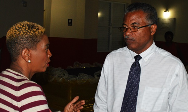 Dr Hubert O'Neal speaks with a resident after the meeting 