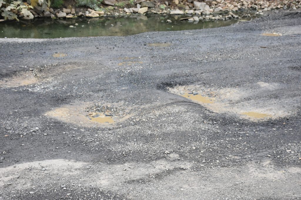 Road paved this month back in disrepair