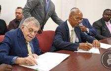 Businessman Dr Henry Jarecki (left) and Premier Dr D Orlando Smith sign an agreement for the development of Norman Island.