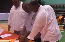 VIP Sixth District candidate John Samuel (centre) is photographed at table of election officials following the conclusion of Monday's 2019 General Election.