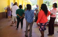Voters queue at a polling station in the Third Electoral District.