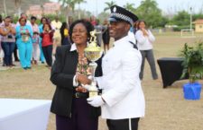 Top police recruit Tuckett is awarded by President of the H Lavity Stoutt Community College Judith Vanterpool.