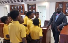 Speaker Julian Willock with Ebenezer Primary School students inside the House of Assembly