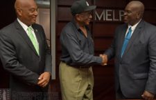 Social Development Minister Carvin Malone (right) shakes hands with project contactor   Victor Creque following the signing of contracts this week. Looking on is Deputy Premier Vincent Wheatley.