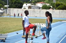 Local pro sprinter, Ashley Kelly in a coaching session with a young athlete.