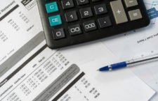 Concept of paying bills. Close up cropped photo with flat lay high angle above top view of object blank calculator and pen