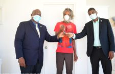 Michael Anthony is handed the keys to his home by Social Development Minister Carvin Malone and Seventh DIstrict Representative Dr Natalio Wheatley.