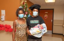 Baby Brielle Mars Maduro is held by her parents after being born just before midnight on January 1, 2021.