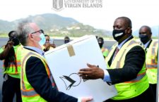 Premier Andrew Fahie handing Governor John Rankin a box of vaccines when they first arrived in the territory.