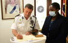 Senior Magistrate Tamia Richards administers the Oath of Office to Commissioner of Police, Mark Collins.