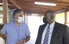 The BVIHSA's Senior Medical Officer, Dr Shaun Ramroop explains rapid antigen testing to Health Minister Carvin Malone. (photo provided)