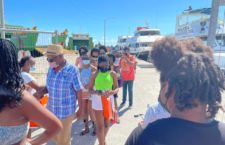 Scores of people coming out of a ferry from Tortola To Anegada to attend the Ninth Annual Anegada Lobster Festival.