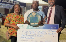 Junior Tourism Minister Alvera Maduro-Caines (left) and Premier Dr Natalio Wheatley (right) present Steven Spencer with a cheque has this year's Junior Chef champion.