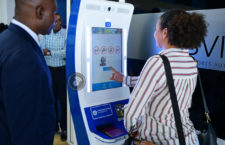 File photo of Deputy Premier Kye Rymer watching as a guest use the new Automated Passport Control kiosk for the first time on Friday, August 19 at the Terrance B Lettsome International Airport. (Photo credit: GIS/ Ronnielle Frazer)