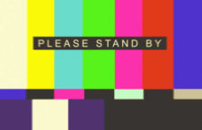 Please Stand By overlaid on vintage television test pattern.