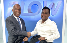 Flow Country Manager, Ravindra Maywahlall is pictured with the Representative for the Ninth
District and Minister for Health and Social Development, Honorable Vincent Wheatley following
a donation of 200 branded backpacks towards the Ninth District Office’s Back to School drive.
(Photo Credit: Flow)